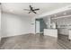Open-concept living room and kitchen featuring stylish gray cabinets, modern lighting, and herringbone floors at 1056 N Miller Rd, Tempe, AZ 85288