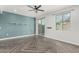 Bright living room features stylish gray herringbone floors, a ceiling fan, and a sliding glass door at 1056 N Miller Rd, Tempe, AZ 85288