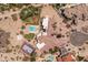 Bird's eye view of the property featuring a swimming pool, sports court, extensive patios, and desert landscaping at 11809 S Montezuma Ct, Phoenix, AZ 85044