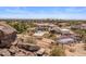 An aerial view showcases a spacious backyard with a pool, spa, sports court, and desert landscaping at 11809 S Montezuma Ct, Phoenix, AZ 85044
