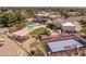 Aerial view showcasing a pool, basketball court, covered patio, and sprawling lawn, perfect for recreation and relaxation at 11809 S Montezuma Ct, Phoenix, AZ 85044