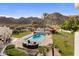 Backyard pool area showcasing a large pool, outdoor kitchen, patio and desert landscape at 11809 S Montezuma Ct, Phoenix, AZ 85044