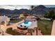 Backyard pool area showcasing a large pool, outdoor kitchen, patio and desert landscape at 11809 S Montezuma Ct, Phoenix, AZ 85044