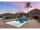 Inviting backyard pool with mountain views, a desert landscape, and an outdoor kitchen area at 11809 S Montezuma Ct, Phoenix, AZ 85044