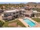 Expansive backyard featuring a sparkling pool, lush lawn, and multiple seating areas for outdoor entertainment at 11809 S Montezuma Ct, Phoenix, AZ 85044