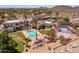 Aerial shot of the backyard oasis with pool, spa, outdoor kitchen, and sports court amid desert landscape at 11809 S Montezuma Ct, Phoenix, AZ 85044