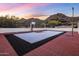 Outdoor basketball court featuring custom blue and red flooring, fencing, and mountain views at 11809 S Montezuma Ct, Phoenix, AZ 85044