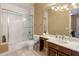 Bright bathroom with tiled shower, large mirror, vanity, and fixtures at 11809 S Montezuma Ct, Phoenix, AZ 85044