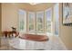 A close up of a bathtub situated in front of a large window that overlooks the outdoors at 11809 S Montezuma Ct, Phoenix, AZ 85044