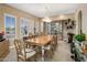 Elegant dining room with chandelier, large windows, and a classic china cabinet at 11809 S Montezuma Ct, Phoenix, AZ 85044