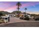 Charming desert home featuring a gated entrance, lush landscaping, and a mountain backdrop at 11809 S Montezuma Ct, Phoenix, AZ 85044