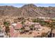Expansive desert home with a pool, lush landscaping, and mountain backdrop at 11809 S Montezuma Ct, Phoenix, AZ 85044