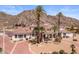 Impressive desert home with a circular driveway and manicured landscaping at 11809 S Montezuma Ct, Phoenix, AZ 85044