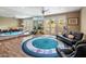 Bright fitness room featuring a large mirror, wood flooring, and exercise equipment at 11809 S Montezuma Ct, Phoenix, AZ 85044