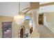 Elegant foyer featuring a grand staircase, chandeliers, and detailed woodwork at 11809 S Montezuma Ct, Phoenix, AZ 85044