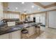 Gourmet kitchen featuring granite countertops, custom cabinetry, an island, and modern stainless steel appliances at 11809 S Montezuma Ct, Phoenix, AZ 85044