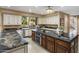Modern kitchen featuring granite countertops, custom cabinetry, tile flooring, and stainless steel appliances at 11809 S Montezuma Ct, Phoenix, AZ 85044