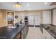 Spacious kitchen featuring dark countertops, an island cooktop, and integrated appliances at 11809 S Montezuma Ct, Phoenix, AZ 85044
