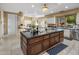 Spacious kitchen with a large island, granite countertops, custom cabinets, and stainless steel appliances at 11809 S Montezuma Ct, Phoenix, AZ 85044