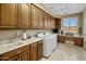 Well-equipped laundry room with modern appliances and ample counter space at 11809 S Montezuma Ct, Phoenix, AZ 85044