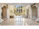 Open living room with floor-to-ceiling windows offering stunning views, a white piano, and elegant decor at 11809 S Montezuma Ct, Phoenix, AZ 85044