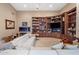 Inviting living room featuring built-in bookshelves, a fireplace, and a cozy white sectional at 11809 S Montezuma Ct, Phoenix, AZ 85044