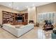 Cozy living room featuring fireplace, built-in bookshelves, and a comfortable white sectional at 11809 S Montezuma Ct, Phoenix, AZ 85044