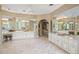 A view of the main bathroom with white marble floor, double vanity, and access to the main bedroom at 11809 S Montezuma Ct, Phoenix, AZ 85044