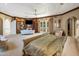 View of a well-appointed main bedroom with a sitting area, built-in shelves, and access to a private balcony at 11809 S Montezuma Ct, Phoenix, AZ 85044