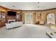 A full view of a main bedroom with a sitting area, fireplace, built-in shelves, and access to a balcony at 11809 S Montezuma Ct, Phoenix, AZ 85044