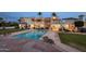 Backyard pool featuring cool water and lounge chairs, with elegant home architecture and a spiral staircase at 11809 S Montezuma Ct, Phoenix, AZ 85044