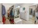 A closet equipped with racks, shelves, dresser, and mirrors for ample storage at 11809 S Montezuma Ct, Phoenix, AZ 85044