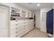A spacious closet equipped with ample shelves, dressers, and storage space at 11809 S Montezuma Ct, Phoenix, AZ 85044