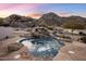 Beautiful rock water feature flowing into a pool adds a tranquil ambiance at 11809 S Montezuma Ct, Phoenix, AZ 85044