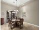 Formal dining room with elegant chandelier and sliding door access to outdoor patio at 12006 E Yucca St, Scottsdale, AZ 85259