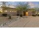 Landscaped front yard with rock garden design and an inviting walkway to the front door at 12006 E Yucca St, Scottsdale, AZ 85259