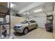 Garage with a light colored SUV, overhead storage and cabinets at 12006 E Yucca St, Scottsdale, AZ 85259