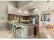 Spacious kitchen featuring bar seating, stainless appliances, and vaulted ceilings at 12006 E Yucca St, Scottsdale, AZ 85259