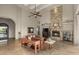 Spacious living room with a stone fireplace and high ceilings at 12006 E Yucca St, Scottsdale, AZ 85259