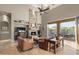 Cozy living room featuring a stone fireplace and access to the outdoor patio at 12006 E Yucca St, Scottsdale, AZ 85259