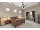 Large bedroom features neutral colors, a ceiling fan, and a private patio at 12006 E Yucca St, Scottsdale, AZ 85259