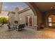 Covered patio with stone fireplace and outdoor seating, perfect for entertaining at 12006 E Yucca St, Scottsdale, AZ 85259