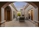 Inviting outdoor patio with a stone fireplace and comfortable seating area at 12006 E Yucca St, Scottsdale, AZ 85259