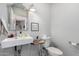 Well-lit half bathroom with modern fixtures, pedestal sink, and classic design at 1246 E Cambridge Ave, Phoenix, AZ 85006