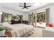 Bright bedroom featuring sliding glass doors leading to the backyard and a ceiling fan at 1246 E Cambridge Ave, Phoenix, AZ 85006