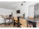 Open dining area with a large dining table, hardwood floors, and access to living area at 1246 E Cambridge Ave, Phoenix, AZ 85006