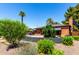 Well-maintained single-Gathering brick home featuring a lush front yard with a variety of plants and trees at 1246 E Cambridge Ave, Phoenix, AZ 85006
