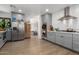 Bright kitchen with gray cabinets, stainless steel appliances, white subway tile backsplash, and light wood floors at 1246 E Cambridge Ave, Phoenix, AZ 85006