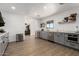 Well-lit kitchen with stainless steel appliances, gray cabinetry, white walls, and hardwood floors at 1246 E Cambridge Ave, Phoenix, AZ 85006