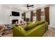 Cozy living room features a fireplace, television, and green leather couch at 1246 E Cambridge Ave, Phoenix, AZ 85006